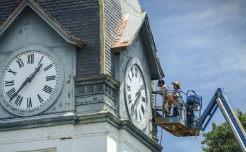 Technicians work on the clock tower of the historic former Fayette County Courthouse on the Square in Fayetteville in this file photo from 2015.