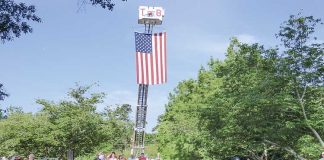 Last year’s Peachtree City Memorial Day observance featured a big crowd and a big flag. File photo.