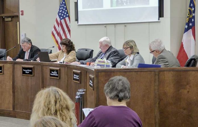 The Peachtree City Council on Dec. 7 approved a bid for intersection work at MacDuff Parkway and Ga. Highway 54 West. Pictured, from left, are Councilman Mike King, Mayor Vanessa Fleisch and council members Terry Ernst, Kim Learnard and Phil Prebor. Photo/Ben Nelms.