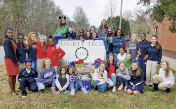 Posing in front of the school sign a year ago are some of the numerous students at Liberty Tech Charter School in Brooks who formed an “Ambassadors 4 Kids” club to prevent bullying. Photo/Submitted.