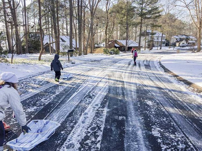 A Peachtree City resident shared this picture of a neighborhood near Lake Peachtree and how some of the neighbors were making use of an uncommon mid-week day off because of snowfall. Photo/Jennifer Vetter.