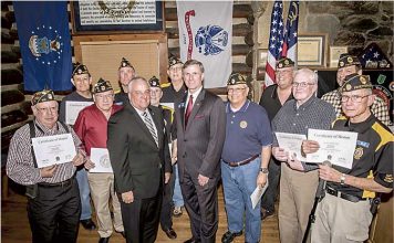 GDVS Commissioner Mike Roby (center, left) and state Sen. Marty Harbin (center, right) presented members of American Legion Post 105 with their Vietnam War Certificates of Honor. The Legionnaires received their certificates at a ceremony held at the “Log Cabin” in Fayetteville in February 2016. Photo/Submitted.