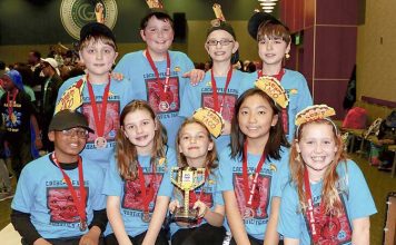 Members of team TACO show off the First Lego League state championship trophy they received for their innovative solution to filling water bottles at drinking fountains. Photo/Fayette School System.