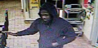 Video surveillance catches armed robbery suspect pointing what looks like a handgun. Photo/Fayetteville P.D.