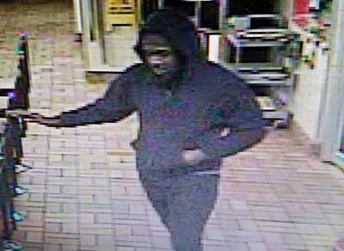Video surveillance catches armed robbery suspect pointing what looks like a handgun. Photo/Fayetteville P.D.