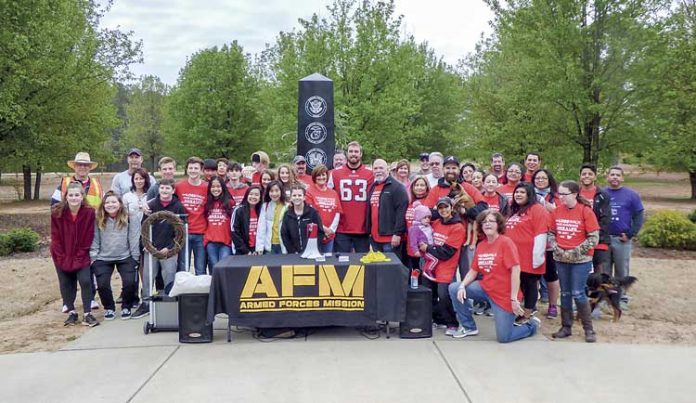 A large group attended the March 24 inaugural LOSS (Local Outreach to Suicide Survivors) Walk at Patriot Park in Fayetteville. Wearing the No. 63 jersey was Atlanta Falcons guard and veteran Ben Garland. Photo/Ben Nelms.