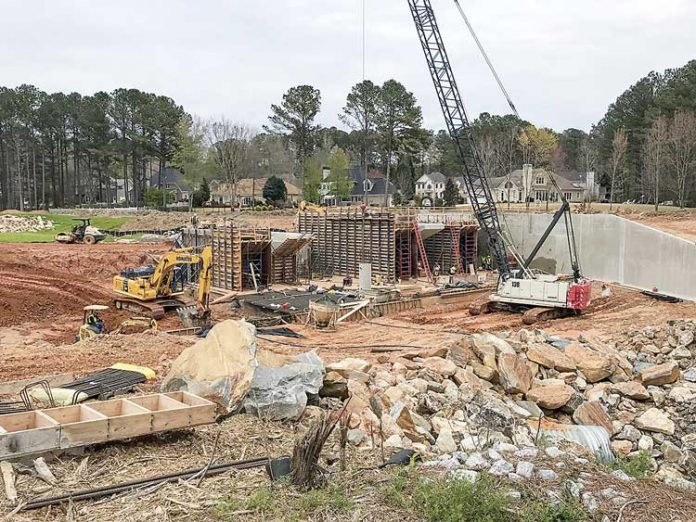 Work on the spillway on Lake Peachtree continues, with substantial completion expected by mid-June. Photo/Ben Nelms.