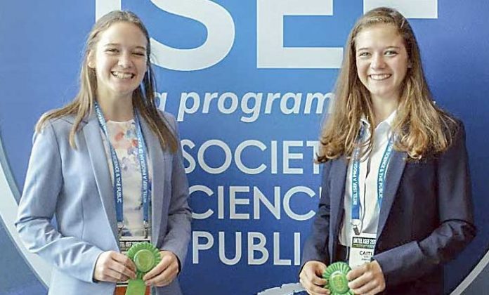 McIntosh High School students and sisters Jacqueline and Caitlin van Zyl show off the fourth place ribbons they won in computational biology and bioinformatics on their first trip to the Intel International Science and Engineering Fair. Photo/Submitted.