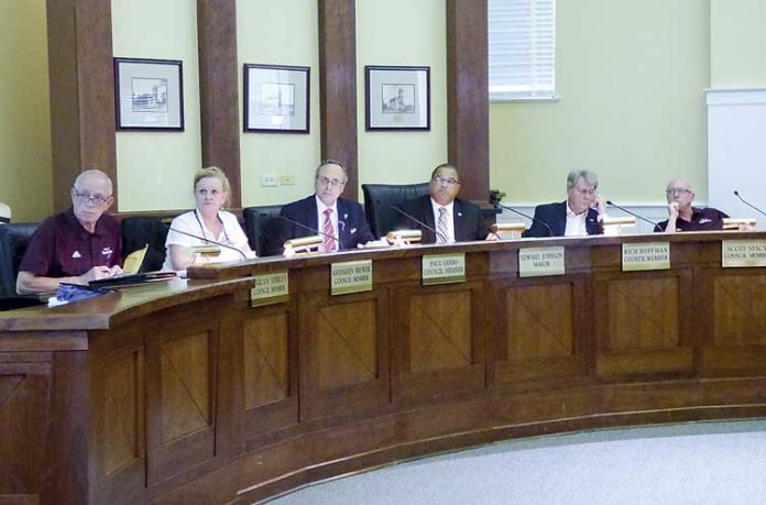 Members of the Fayetteville City Council at the June included, from left, council members Harlan Shirley, Kathaleen Brewer and Paul Oddo, Mayor Ed Johnson and council members Rich Hoffman and Scott Stacy. Photo/Ben Nelms.