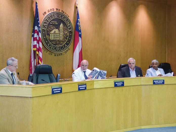 Members of the Fayette County Commission at the Aug. 9 meeting include, from left, Commissioner Chuck Oddo, Chairman Eric Maxwell and commissioners Randy Ognio and Charles Rousseau. Photo/Ben Nelms.