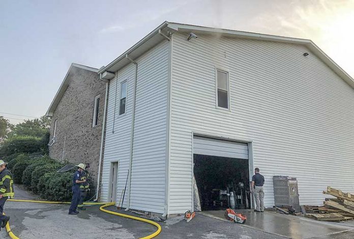 Firefighters clean up following an Aug. 24 fire at Fayette Floor and Wallcovering in Fayetteville . Photo/Fayetteville Fire Department.