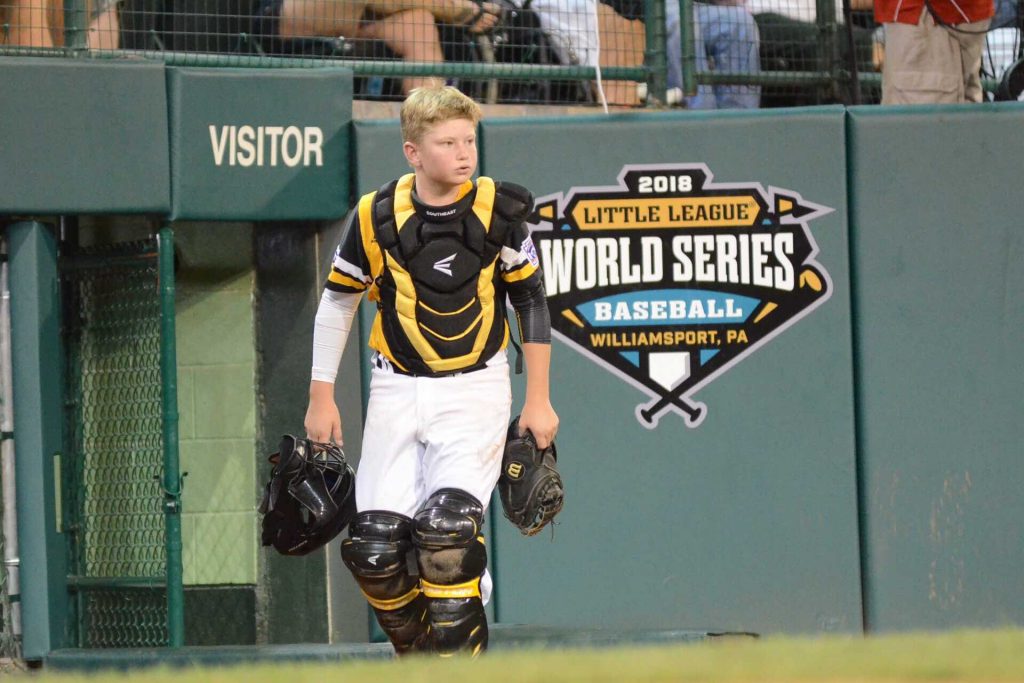 Peachtree City’s Chase Fralick heads out to the field during a Little League World Series game against the Northwest. Fralick has caught every inning for Peachtree City, which opened with the longest recorded game in Series history. Photo/Brett R. Crossley.