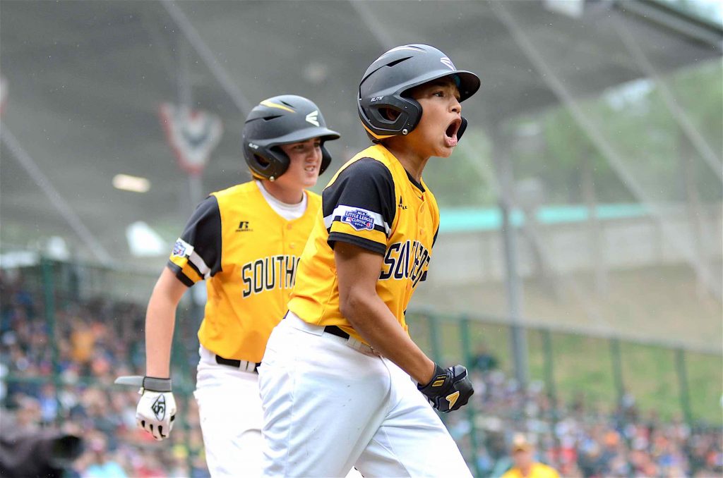 Peachtree City’s Tai Peete celebrates a run during a Little League World Series game against the Great Lakes. Photo/Brett R. Crossley.