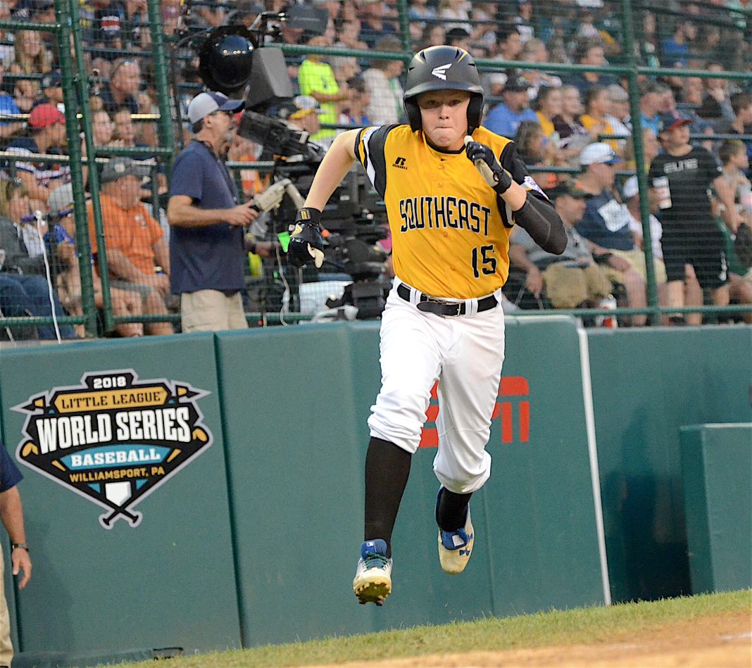 Peachtree City’s Connor Riggs-Soper runs home after reaching base with a double during the second inning of a Little League World Series game against the Mid-Atlantic. Photo/Brett R. Crossley.