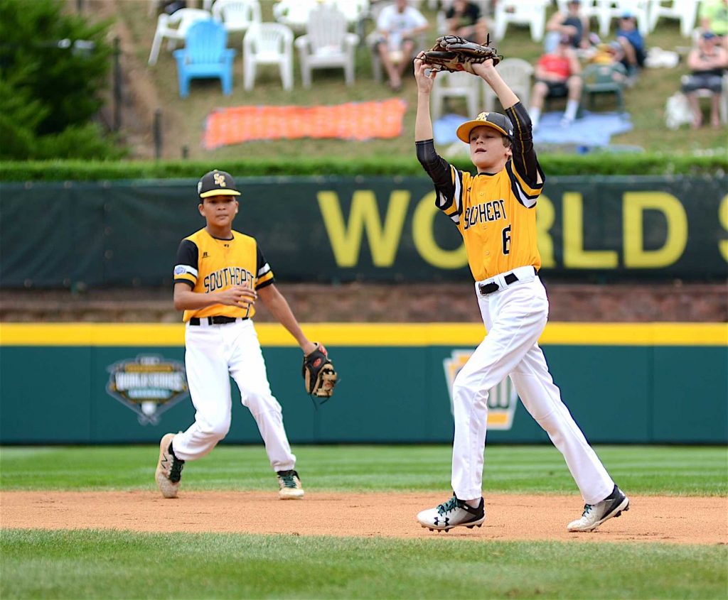 Peachtree City’s Wills Maginnis makes a catch on a pop fly during the fifth inning of the Consolation game of the Little League World Series against Japan. Tai Peete backs him up. Photo/Brett R. Crossley.
