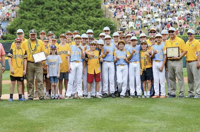Competitors become friends — It’s a mixture of the world’s best Sunday, as members and coaches of the Peachtree City American Little League team (in yellow jersies) mingle with the World Series winner Hawaii after both teams received an unprecedented honor: A joint sportsmanship award. Photo/Brett R. Crossley.