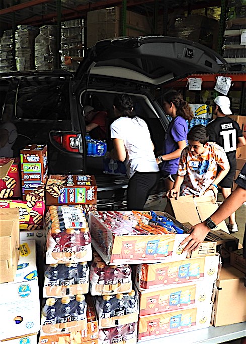 Volunteers load supplies onto vehicles at Midwest Food Bank in Peachtree City. Photo/Midwest Food Bank.