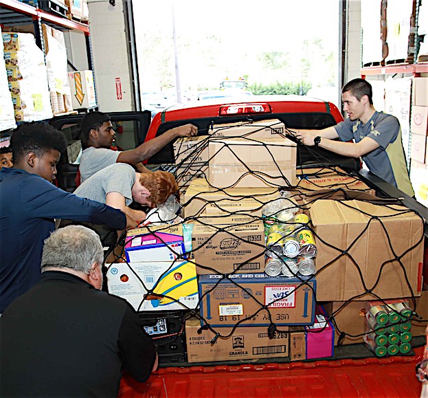 Volunteers secure a load of donated food. Photo/Midwest Food Bank.