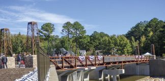 A large number of city, county, state and federal elected and appointed officials were joined by citizens Oct. 18 for the dedication of the Lake Peachtree spillway in Peachtree City. Photo/Ben Nelms.