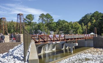 A large number of city, county, state and federal elected and appointed officials were joined by citizens Oct. 18 for the dedication of the Lake Peachtree spillway in Peachtree City. Photo/Ben Nelms.