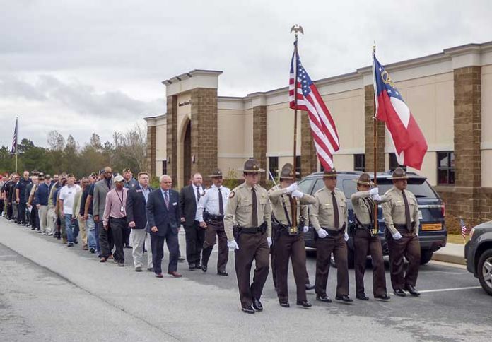 Fayette County law enforcement and first responders march with veterans at a commemorative ceremony for Veterans Day at Georgia Military College in Fayetteville. Photo/Ben Nelms.