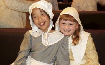 Crossroads Christian School fifth-grade students Hannah Cooke and Katie Ferrell take a moment after their school’s Thanksgiving play Nov. 15. Every student performed in “The First Thanksgiving,” which commemorates the Pilgrims’ quest for religious freedom, God’s provision, and the friendship of Native Americans to the newcomers. Photo/Submitted.