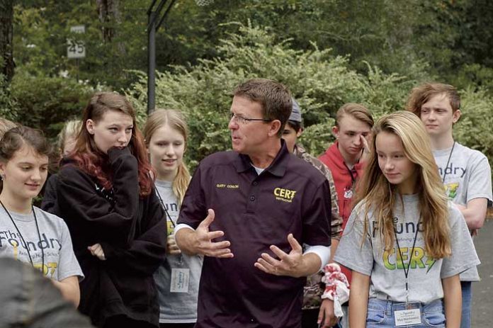 Peachtree City Police Department CERT (Community Emergency Response Team) trainer Gary Conlon works with The Foundry School students. Photo/Submitted.