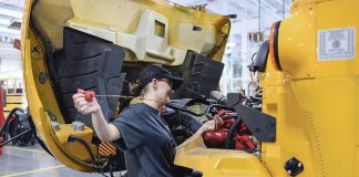 Lindsey Crook performs routine maintenance check on one of the school system’s buses. Photo/Fayette County School System.