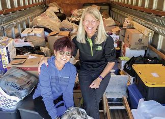Kathy Gloer and friend Sandi Donaldson help to load a trailer full of relief supplies for hurricane victims in the Florida panhandle. Photo/Hearts with Hope Facebook page.