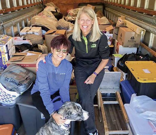 Kathy Gloer and friend Sandi Donaldson help to load a trailer full of relief supplies for hurricane victims in the Florida panhandle. Photo/Hearts with Hope Facebook page.