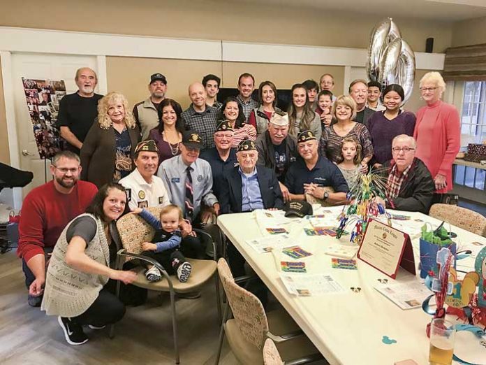 Family, friends and local veterans on Dec. 1 honored World War II veteran Salvatore Bordonaro (front, center) at his 100th birthday party. Photo/Ben Nelms.