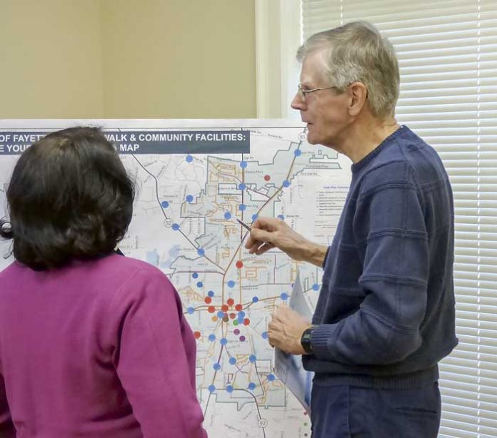 Fayetteville City Planner LaShawn Gardiner (left) discusses city planning activities with Richard Sprague at a Nov. 28 meeting at Fayette Senior Services. Photo/Ben Nelms.