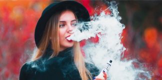 Shutterstock image of woman holding a vaping device.