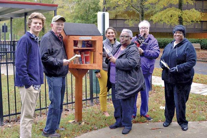 Cooper Roman, an Eagle Scout and Peachtree City resident, recently built and installed four Little Free Libraries on the campus of Christian City. Cooper is pictured with several active senior residents and staff at the library located next to the Dog Park. From left are Cooper Roman, Danny O’Neal, Tyler Wright, Director of Campus Recreation, Arlene White, Gloria Kerns (with her dog Zippy), and Renee Trice. Photo/Larry Regier.