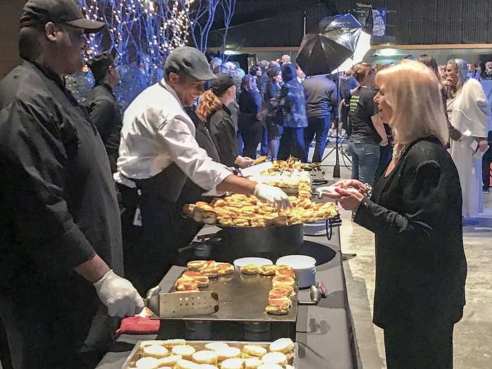 Guests line up for the food served up by Hannah Brothers catering. Photo/Ben Nelms.