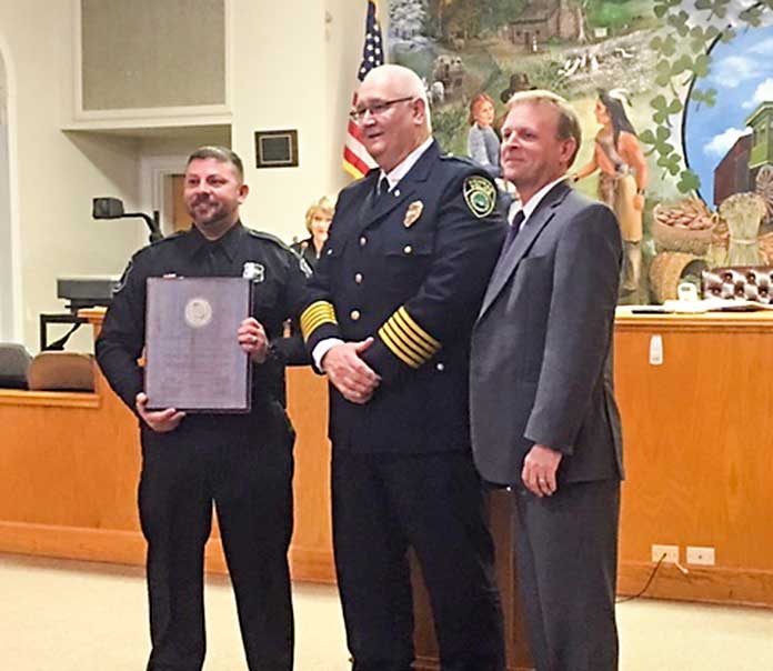 Tyrone Police Lt. Eric DeLoose (L), Newnan Police Chief Buster Meadows and Tyrone Mayor Eric Dial give the audience at the Jan. 17 meeting of the Tyrone Town Council its first look at the police department’s state certification, awarded by the Ga. Association of Chiefs of Police. Photo/Submitted.