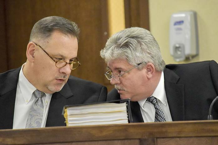 Peachtree City Manager Jon Rorie (R) confers with City Attorney Ted Meeker at a City Council meeting. Photo/Cal Beverly.