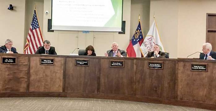 Members of the Peachtree City Council listen to Councilman Terry Ernst (3rd from right) explain his vote against a trash pickup proposal. Also shown are (L-R) City Manager Jon Rorie, Councilman Mike King, Mayor Vanessa Fleisch, Ernst, Councilman Kevin Madden and Councilman Phil Prebor. Photo/Cal Beverly.