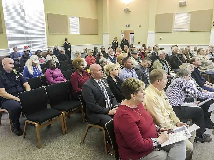 Below, a group of neighbors southeast of a helipad site approved March 7 by the Fayetteville City council spoke in opposition to a plan by Air Evac to establish a one-chopper, emergency medical transport site on Promenade Parkway in the Fayette Pavilion area. Photo/Ben Nelms.