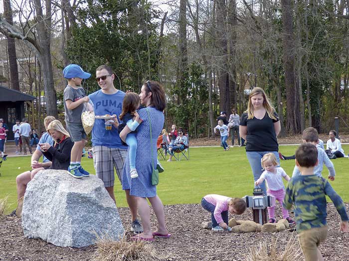 Parents and children play and talk at Drake Field near City Hall Plaza in Peachtree City. Photo/Ben Nelms.