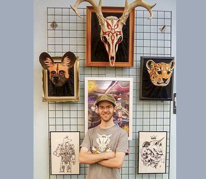 Eric Strother, one of three artists exhibiting in the POW!POP! exhibit in the Peachtree City Library Art Initiative, stands in front of a few of his fantastic masks. The exhibit continues through June with a reception Sunday, June 2, from 3 TO 4:45 p.m. at the Peachtree City Library, Willow Bend Road, Peachtree City.