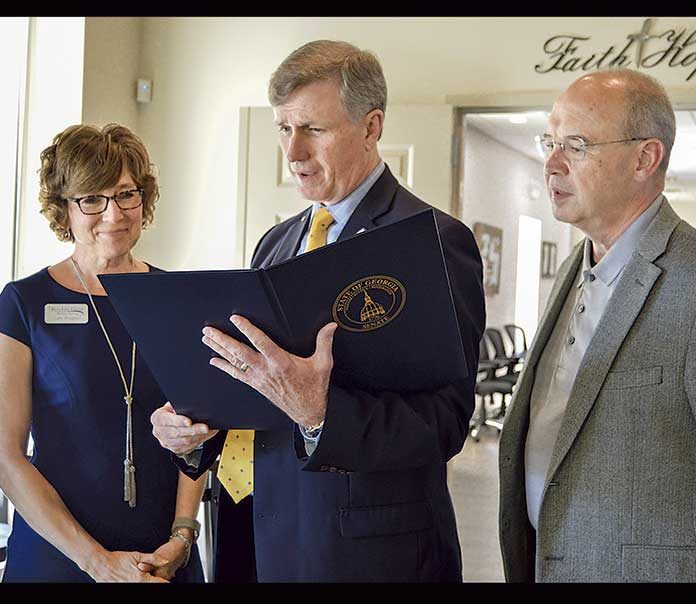 Senator Marty Harbin signs and presents Georgia Senate Resolution, Monday, May 13, at Real Life Center’s ribbon cutting. Pictured are Real Life Center Executive Director, Cathy Berggren, Senator Harbin, and Dogwood Church Lead Pastor Keith Moore. Photo/Debbie Hembry.
