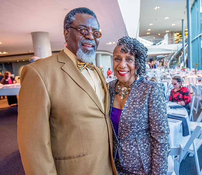 Fayetteville residents Tony and Novena McGee are pictured among the dining tables in the atrium during the 2nd annual Drive & Dine event at Porsche Experience Center benefitting Christian City Children & Family Programs. Photo / Chris Rank Photography