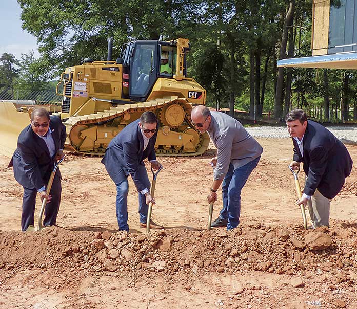 Shoveling the first dirt for the nearly 53,000 sq. ft. Two Ten office and retail building at Pinewood Forest on May 17 were, from left, Fayetteville Mayor Ed Johnson, Pace Lynch Principal Jason Pace, Pinewood Forest President Rob Parker and Pace Lynch Principal Bill Lynch. Photo/Ben Nelms.