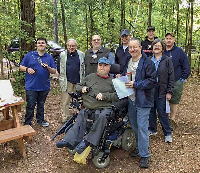 Pictured are (L-R) Ryan Bibby (KN4RQL), John Snellen (AI4RT), Brian Haren (W8BYH), Bob Gibler (NF5F), Jason Kirkbride, Tom Kirkbride (K1EOD); front, from left: Huey Kenmar (KI4NGD), Jeff Anderson (KK4BCH), Karen Gibler (KA5TFQ). Photo/Joe Domaleski (KI4ASK).