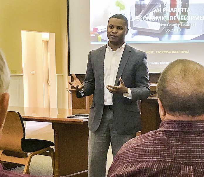 Alpharetta Development Manager Matthew Thomas recently gave Fayette County Development Authority members and local elected officials a look at what his city accomplished in bringing about the expansive Avalon mixed-use development. Photo/Ben Nelms.