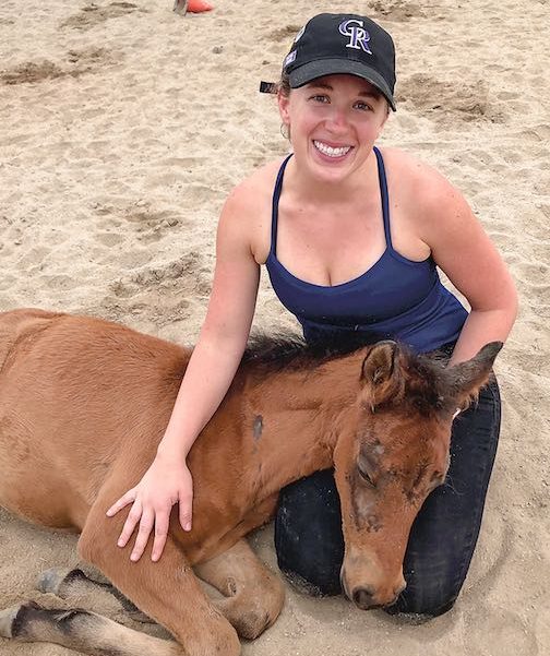 Volunteer and Coweta County resident Rachel DeMuth with a nurse mare foal at the Flying Change farm. Submitted.