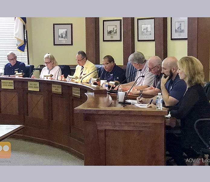 Pictured at the July 18 meeting, from left, are council members Harlan Shirley, Kathaleen Brewer and Paul Oddo, Mayor Ed Johnson, council members Rich Hoffman and Scott Stacy, City Manager Ray Gibson and City Clerk Anne Barksdale. Photo/Ben Nelms.