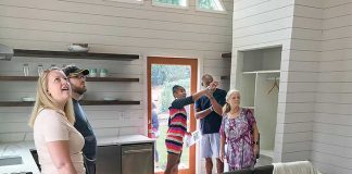 Visitors at the 536 sq. ft. “Peak” micro home at Pinewood Forest on July 20 got a look at a sampling of the smart home technology with which all six homes in the development’s first Micro Home Village are outfitted. Photo/Ben Nelms.