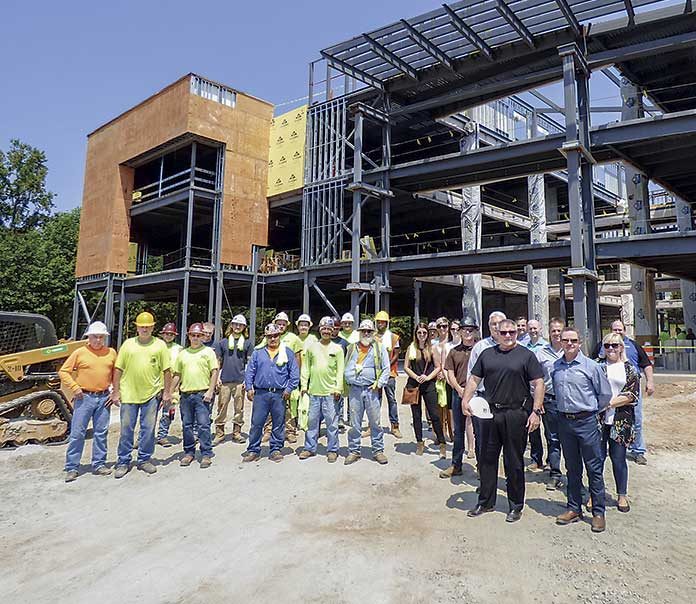 South-Tree Enterprises construction workers, building owners and architects on Aug. 1 attended the “topping off” of the new SMC3 office building on Lexington Circle in Peachtree City. Photo/Ben Nelms.